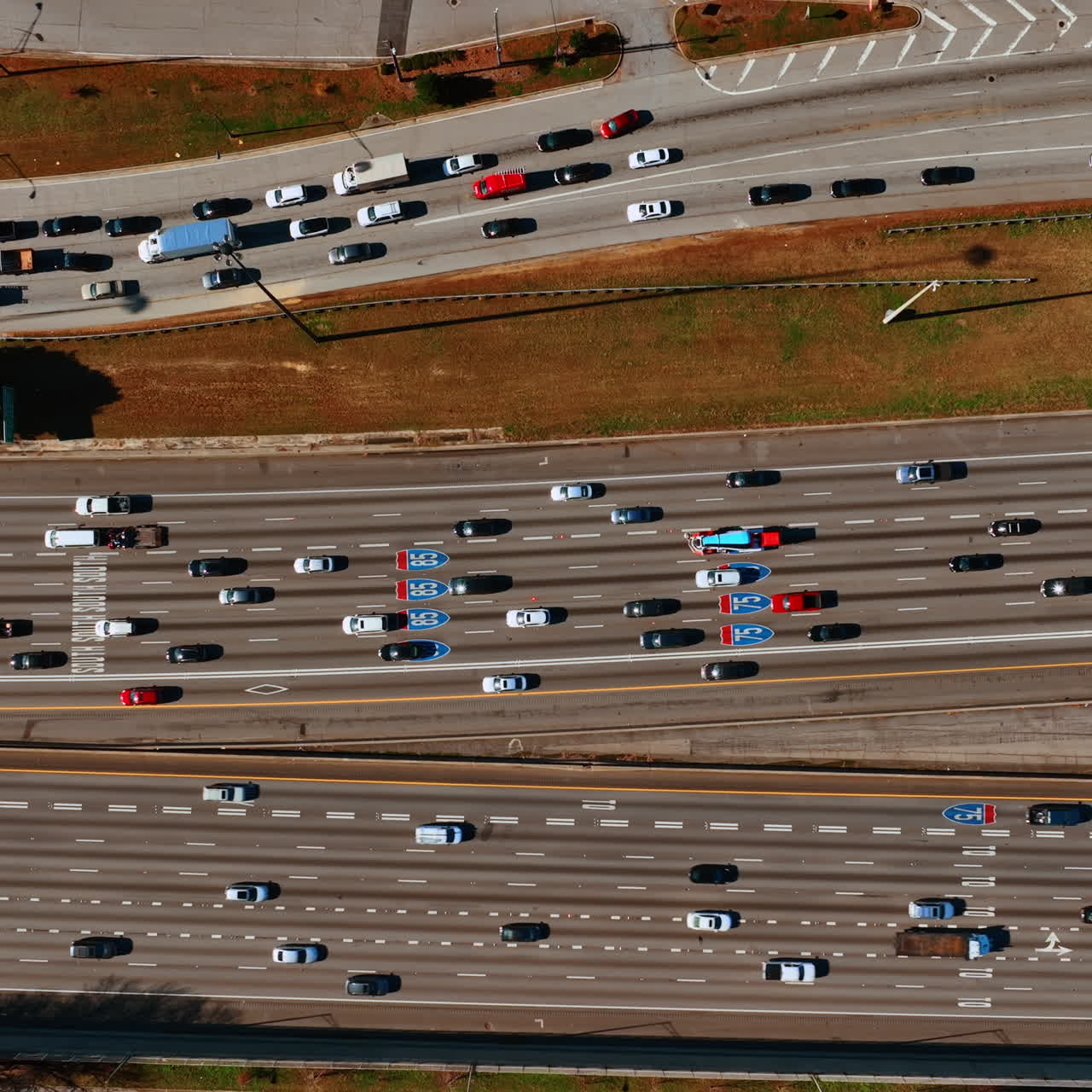Private transport going by the multi-lane roads. Top view on the highway at daytime.
