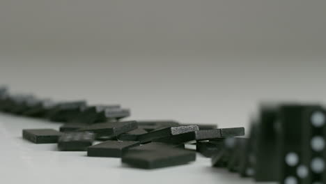 rows of black dominoes with white dots