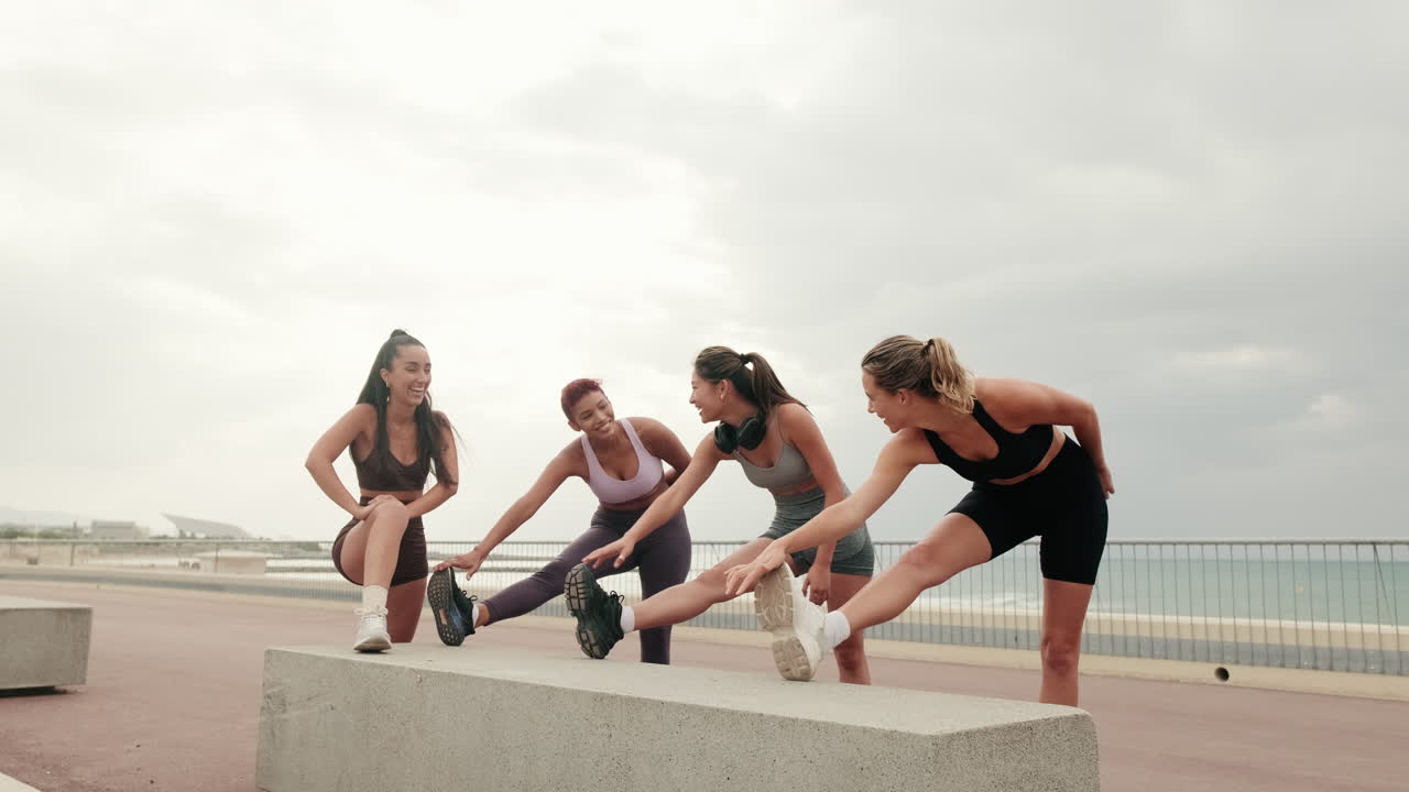 Happy Female Friends Stretching by the Sea
