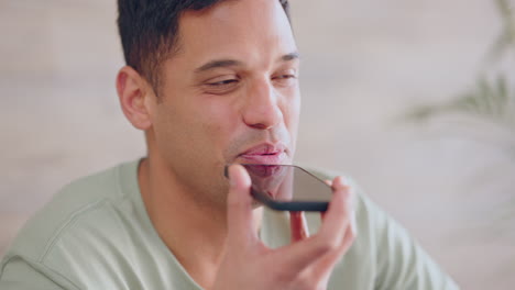 man talking on audio call with phone in house