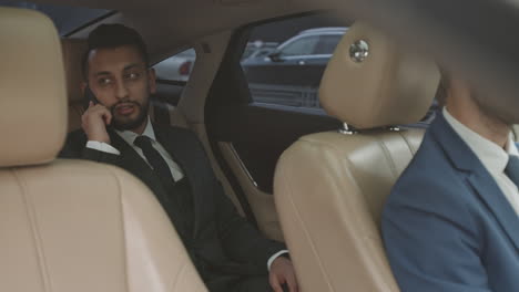 mixed-race businessman in car with driver