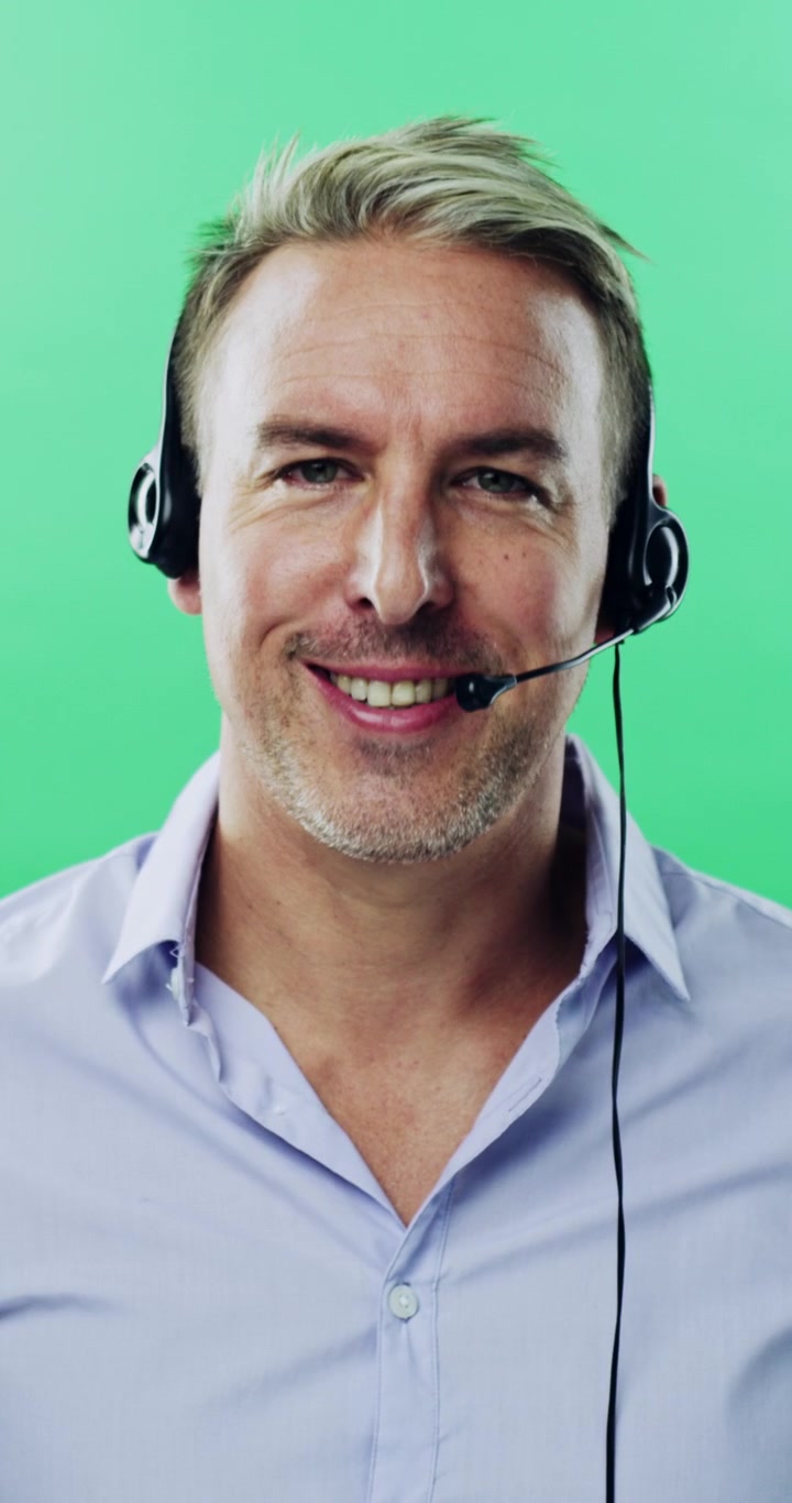 Friendly Customer Service Representative Talking on Headset Against Green Screen
