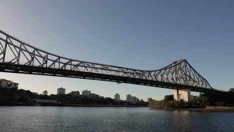 Wide-low-view-of-the-Story-Bridge-at-sunrise-from-the-City-Reach-Boardwalk,-Brisbane-City,-Queensland,-Australia