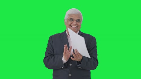 Happy-Indian-senior-manager-congratulating-employees-Green-screen