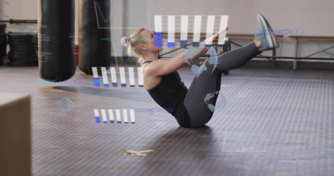 Pausing on rubber mat, engaging core, woman lifting arms and legs into V-up for fitness training