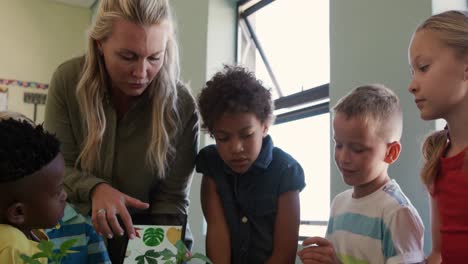 female teacher teaching about plants in class