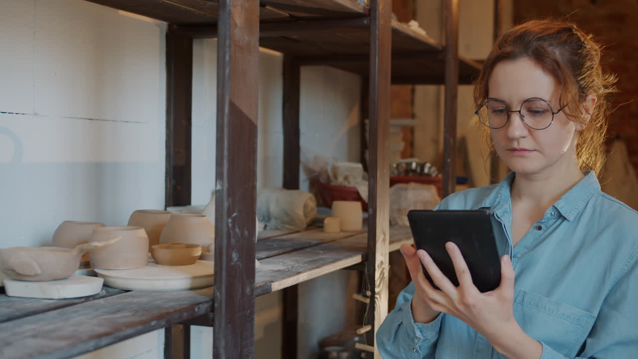 Woman Pottery Artist Working in Studio