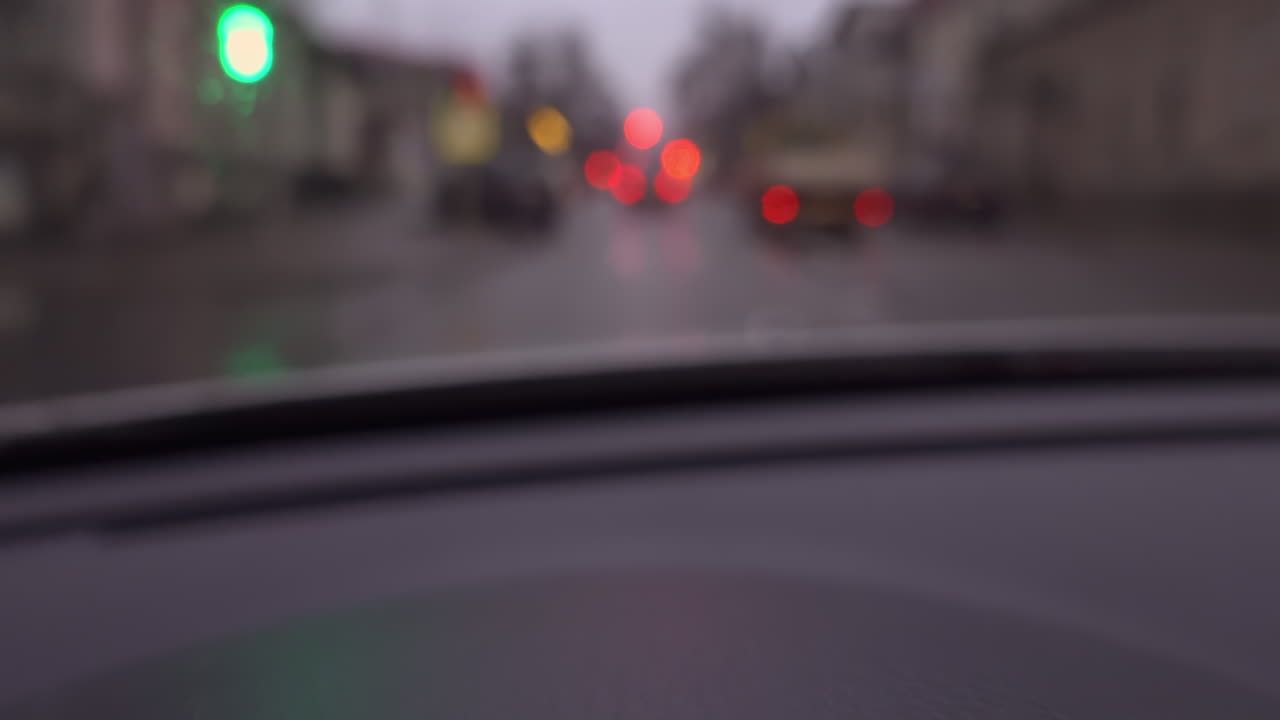 Blurred view from a car window of the streets of Chisinau, Moldova on a rainy evening