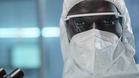 portrait of black lab scientist in protective suit and mask