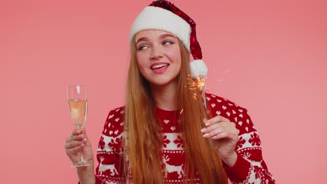 Lovely-girl-in-Christmas-Santa-sweater-dancing-with-bengal-sparklers-fireworks-and-champagne-glass