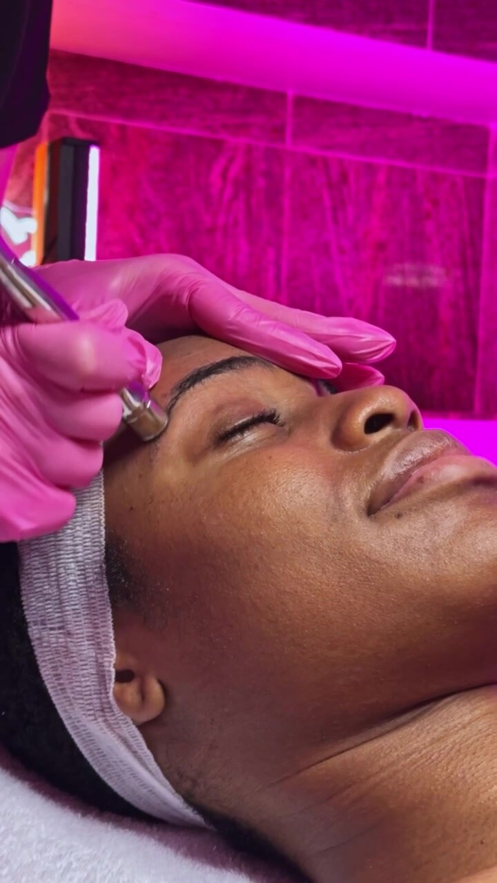 Beauty treatment takes place in a modern salon with a focus on eyebrow shaping in a vibrant environment filled with bright colors and relaxing vibes