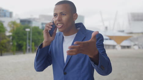 emotional african american man talking on smartphone.