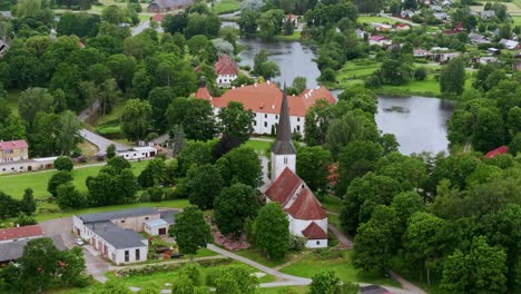 drone fly right with slight descent showing jaunpils castle, church off horizon