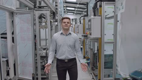 manager of factory gives tour of the warehouse full of equipment