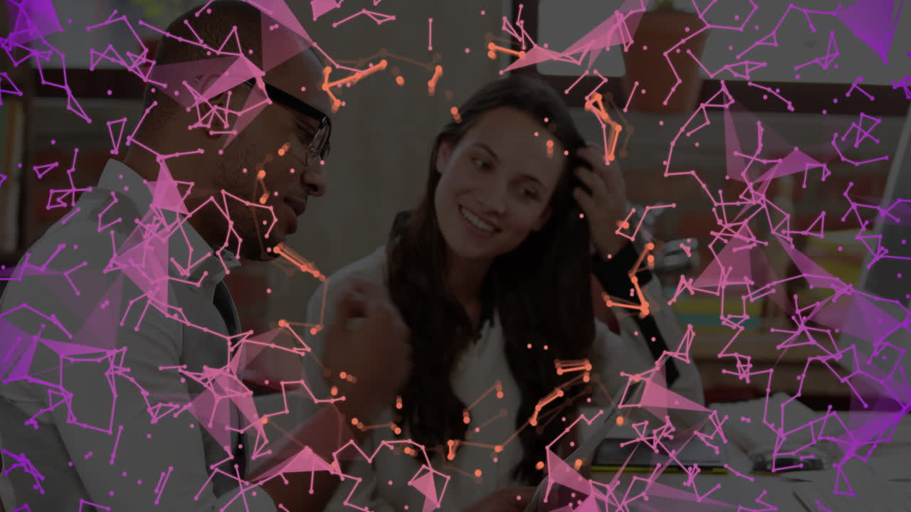 Two people discussing work with abstract pink and orange network animation overlay