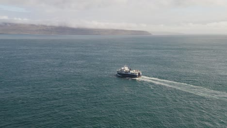 aerial view of ferry boat with passengers cruising in the ocean from sandoy to streymoy in the faroe islands