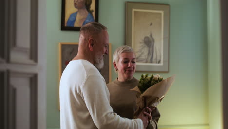 man bringing flowers to woman