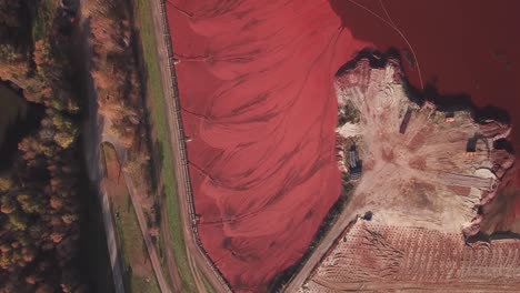 top-down aerial view of environmental, industrial waste, red mud or red sludge deposits in stade, lower saxony, germany