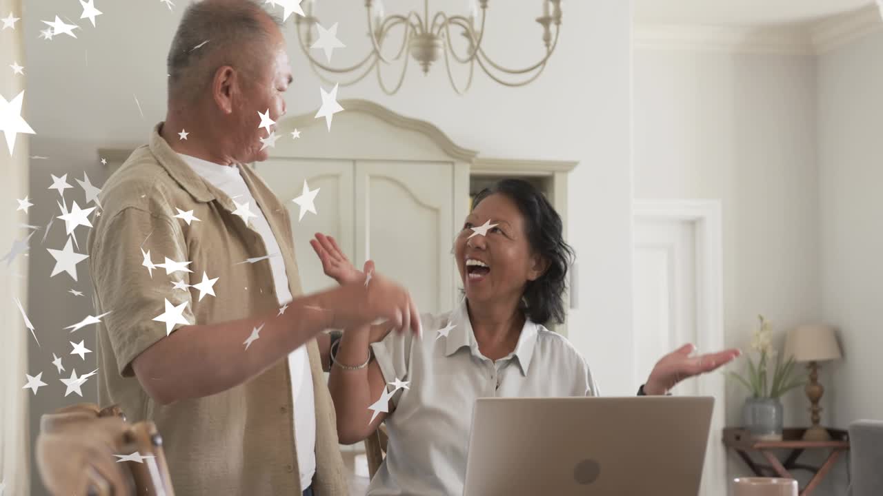 Man leaning, showing card, woman typing on laptop, making payment while star overlay sparkling