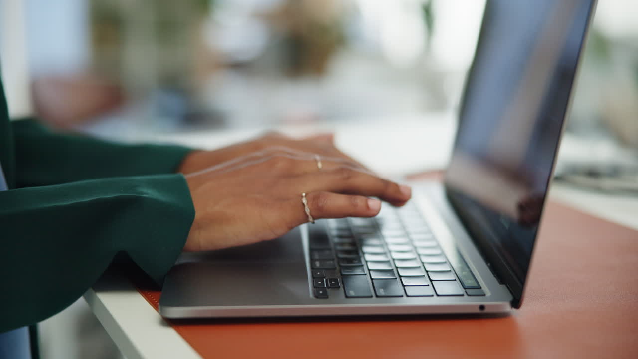 Close Up of Hands Typing on Laptop Keyboard