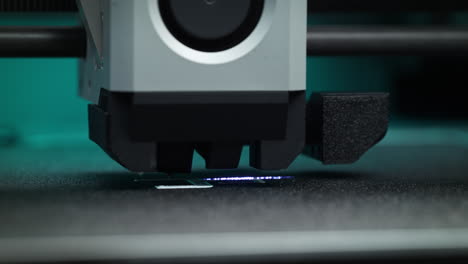 3d printer performing precise laser scanning of the first layer of 3d print filament and calibrating the flow in macro