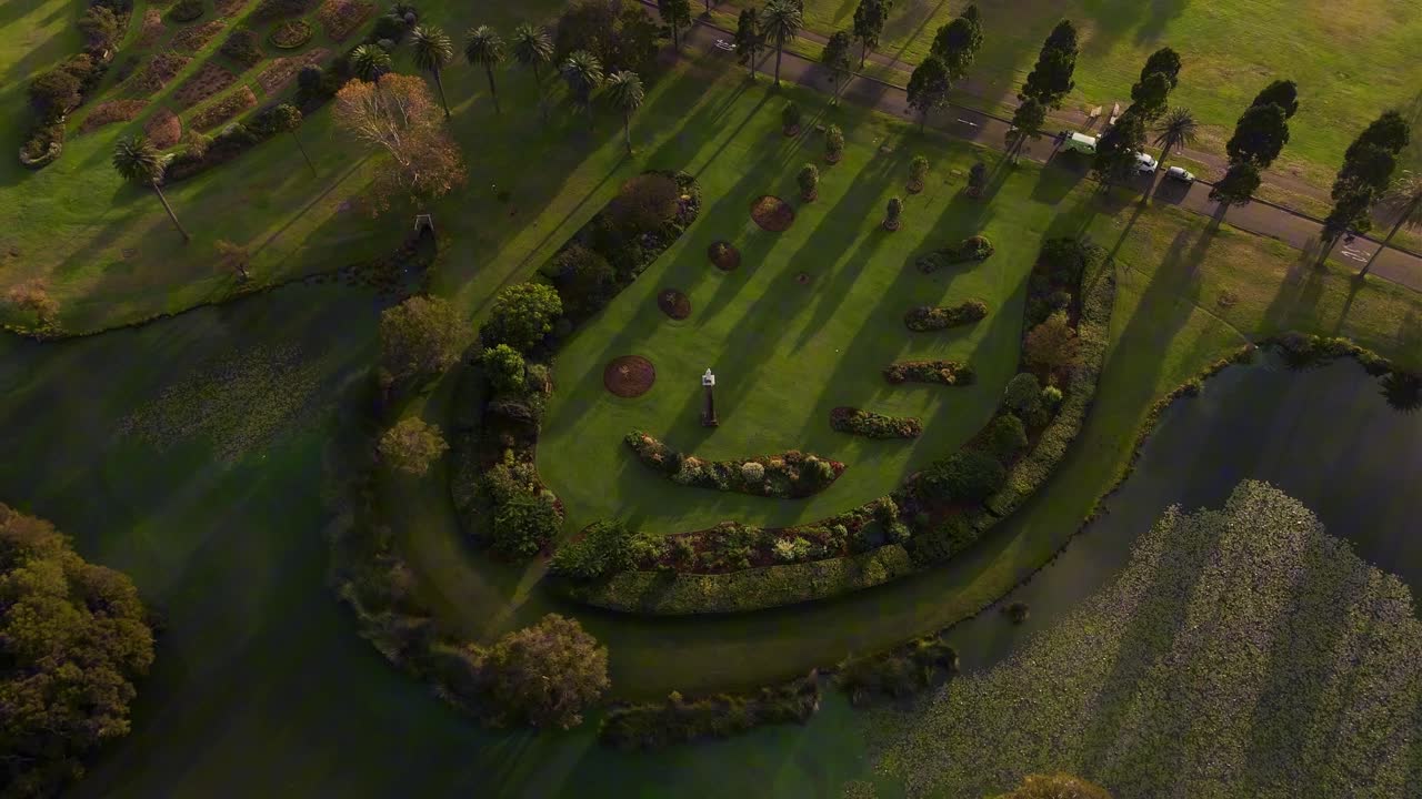 Drone over a circular garden formation surrounded by greenery in Centennial Park, Sydney NSW Australia