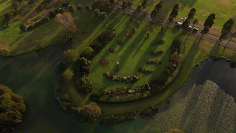 drone over a circular garden formation surrounded by greenery in centennial park, sydney nsw australia