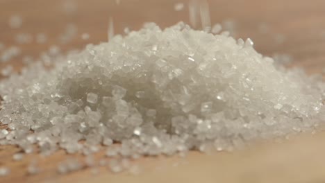 close-up of white sugar crystals being poured