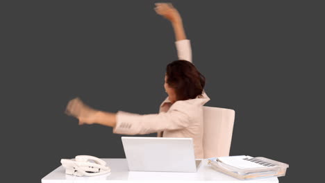 businesswoman celebrating at her desk