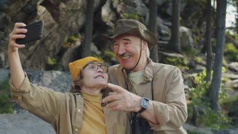 senior couple taking a selfie in the mountains