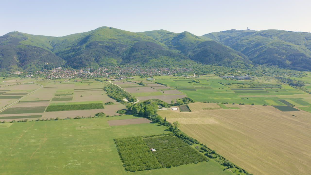 Drone panning from the right to the left on a picturesque landscape where the Tomb of Golyama Kosmatka is located in the valley of the Thracian kings in Bulgaria.