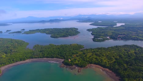 sliding over a spectacular view of a small chain of islands of boca chica in panama from a drone flying high in the sky