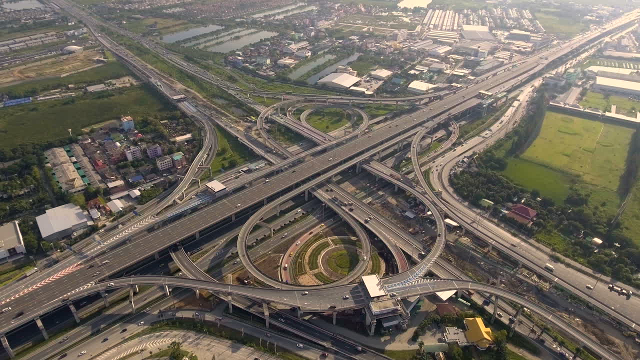 Aerial View of Highway Road Interchange with Busy Urban Traffic Speeding on Road