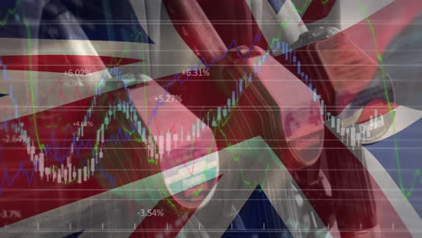 animation of waving uk flag and financial data processing over petrol pumps