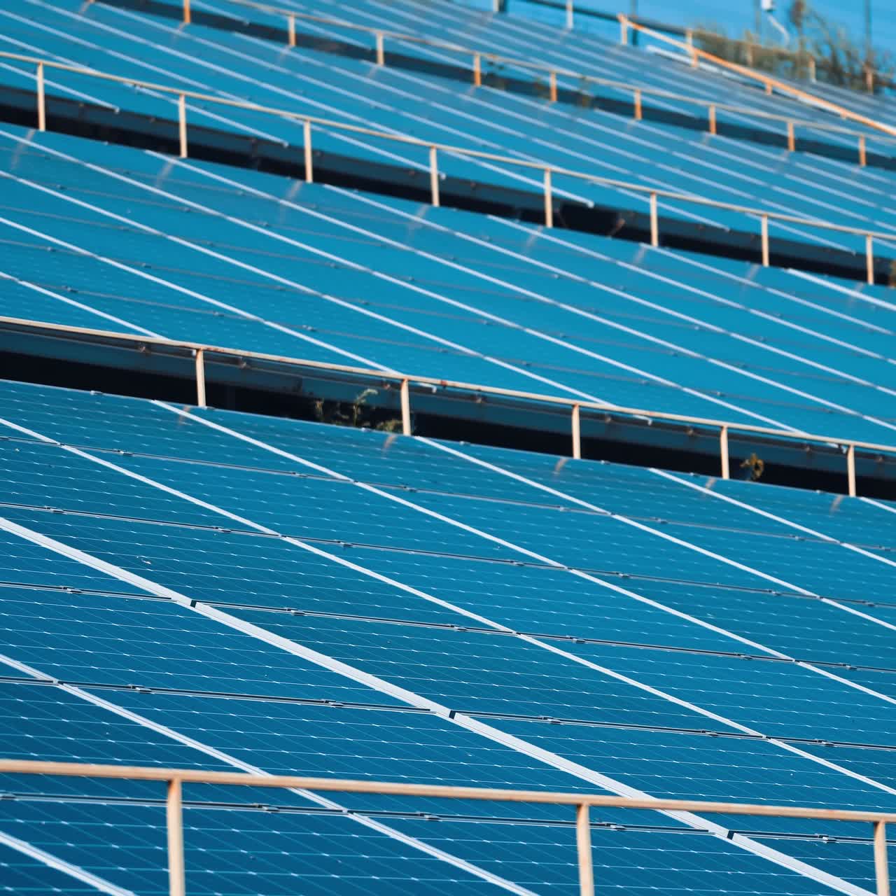 Solar panels stand in a row in the fields of green energy landscapes. Alternative sunlight energy technology