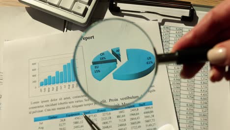 Close-up of Financial Report with Magnifying Glass