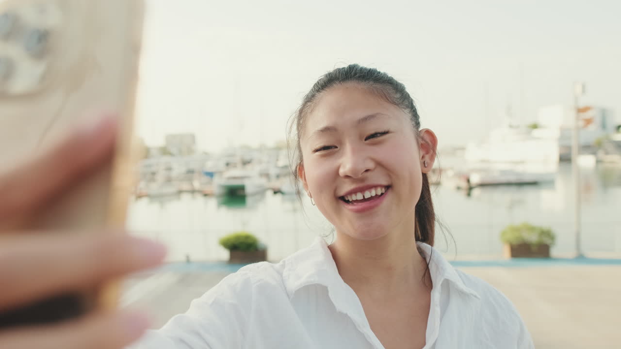 Woman taking a selfie in a marina