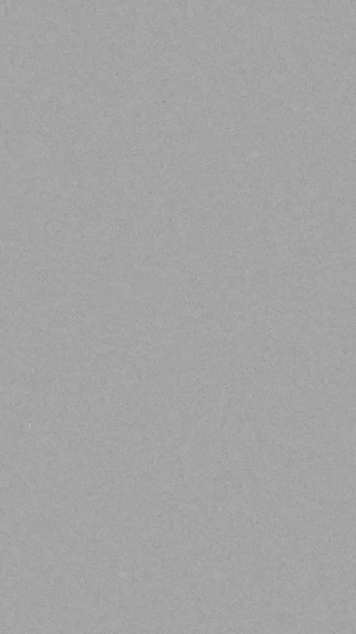 Vertical format 16mm film grain overlay with authentic noise and dust for retro documentary look, seamless loop