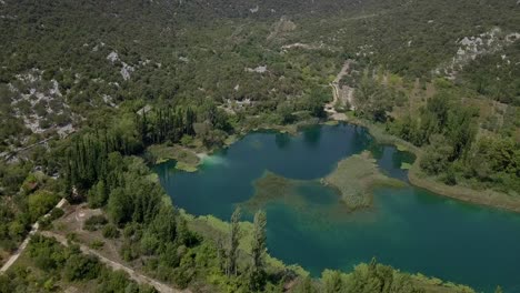 AERIAL:-Green-plantations-and-lake-in-Croatia