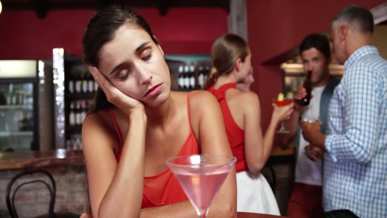 Sad woman sitting in bar