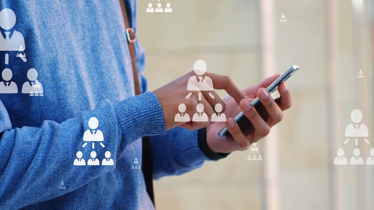 Animation of user icons over midsection of biracial man using smartphone