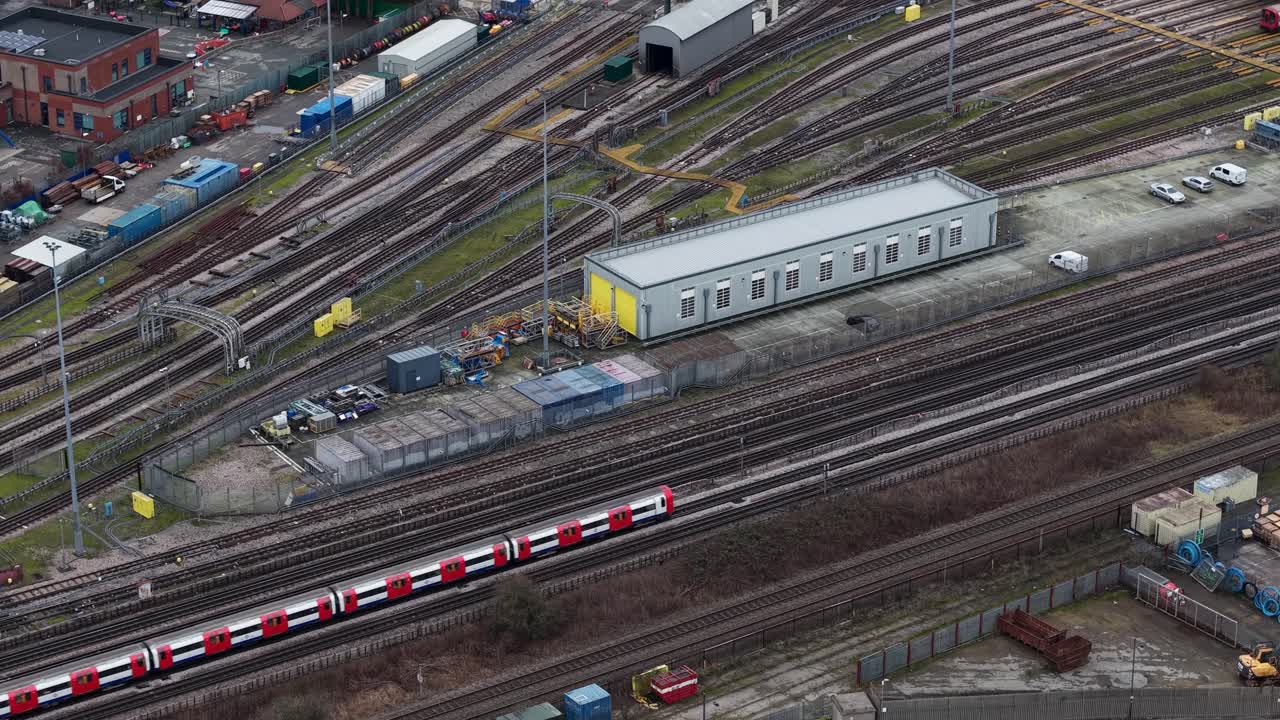 Aerial view looking down at train passing through Wembley suburbs taking commuters to London city