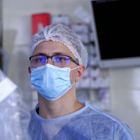 futuristic robotic machine perform surgery. doctor in mask looking at the medical process of robotic equipment during surgery. modern medicine. close-up.