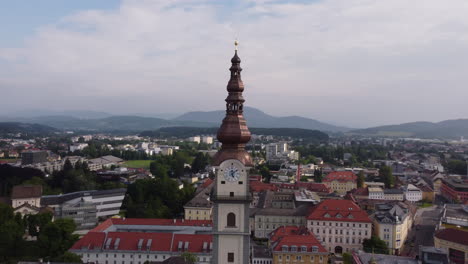 aerial circling klagenfurt cathedral clock tower, revealing cityscape, austria