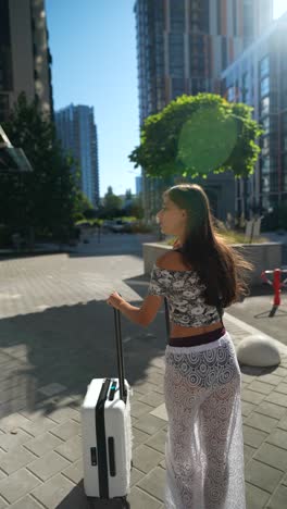 woman walking with suitcase in city