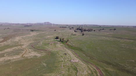 drone aerial view, wind farm of wind turbines in remote barren landscape, israel