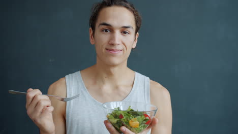 young man eating salad