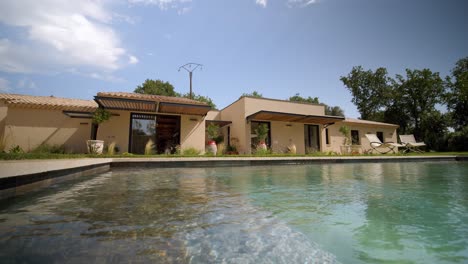 low-angle revealing shot of a luxury villa with a private pool in the garden