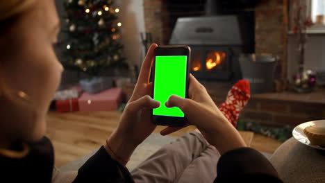 woman on line with mobile phone in room ready for christmas