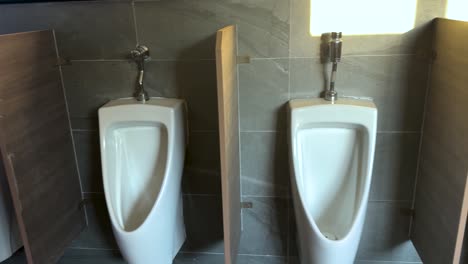 urinals in a public male restroom